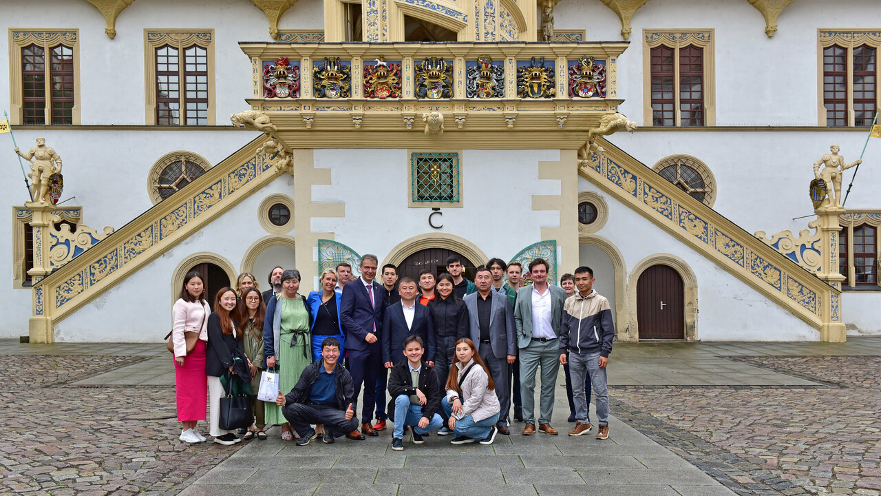 Gruppe Menschen vor einem Schloss